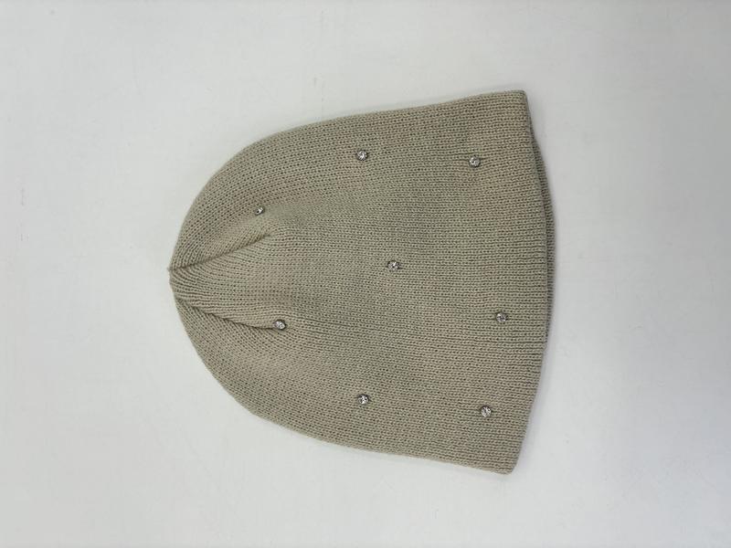 Sage green fine knit beanie hat with scattered silver crystal rhinestone studs, laid flat on white background