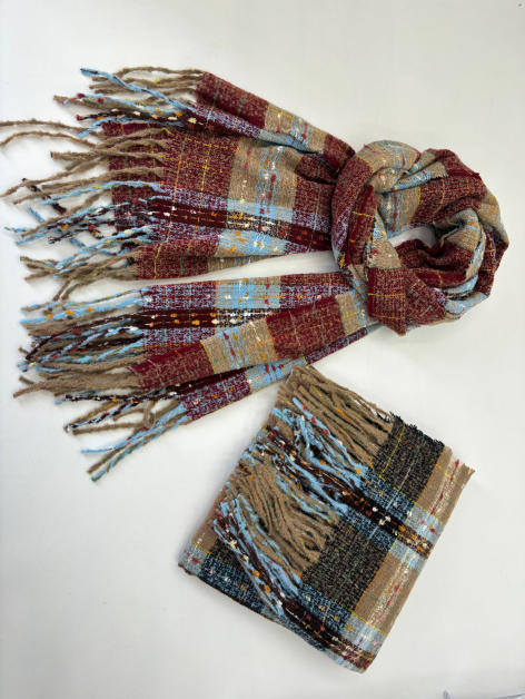 Plaid woven scarf in burgundy, light blue, and tan with fringe ends, shown draped and folded on white surface