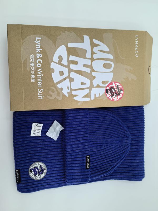 Royal blue ribbed knit beanie hat and matching scarf winter set laid flat beside kraft gift box packaging