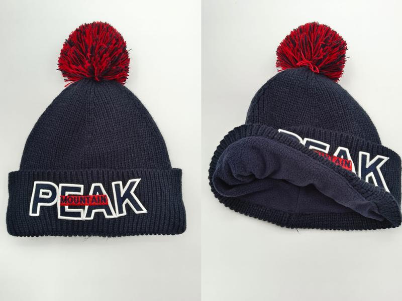 Navy blue ribbed knit beanie with red pom-pom and embroidered PEAK MOUNTAIN logo on folded cuff, front and interior view
