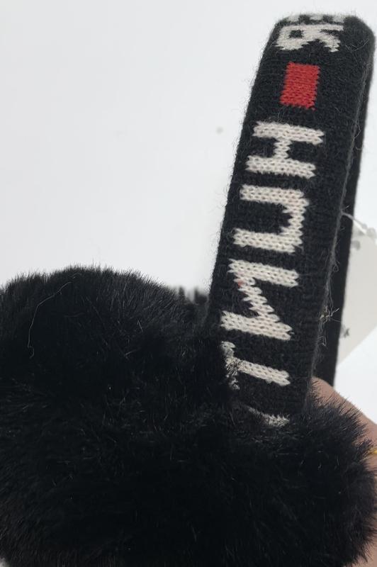 Gray fluffy faux fur earmuffs with tan suede-style headband displayed flat on white background with product tag