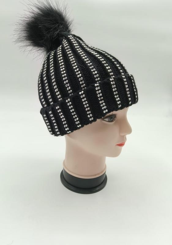 Black ribbed knit winter beanie with silver rhinestone stripes and black faux fur pom-pom on mannequin head
