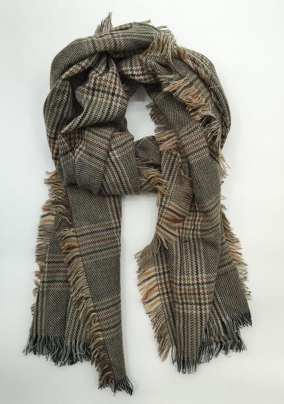 Olive green and beige plaid woven scarf with fringe edges, loosely knotted on white background