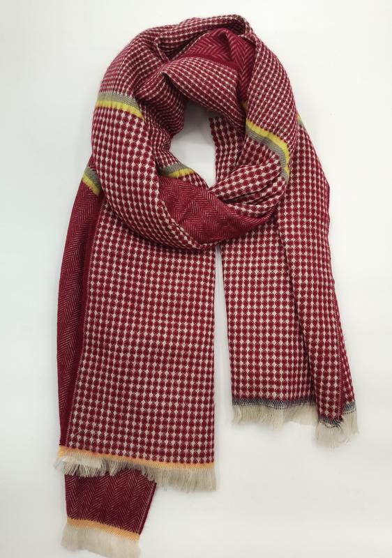 Red and ivory diamond houndstooth patterned woven scarf with yellow stripe accents and fringe ends, loosely looped