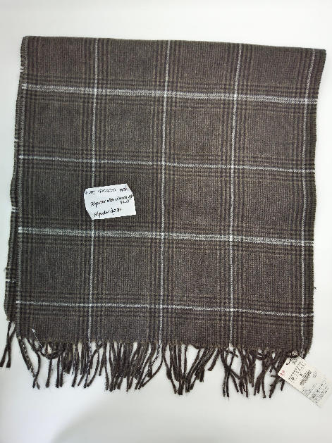 Flat lay of a brown and white glen plaid woven scarf with twisted fringe trim, polyester viscose blend
