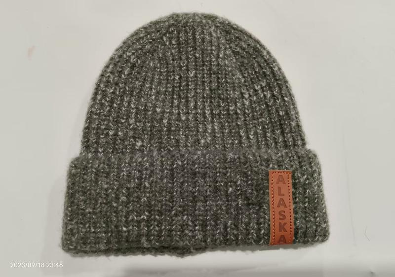 Gray marl ribbed knit cuffed beanie hat with brown leather Alaska patch label on folded brim