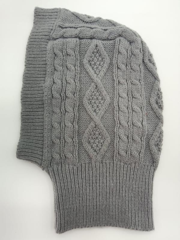 Grey cable knit balaclava laid flat showing diamond and twisted cable stitch pattern with ribbed edges