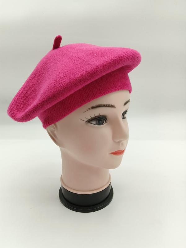 Hot pink wool knit French beret hat displayed on a mannequin head, side view showing classic round shape and center top button