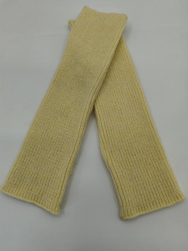 Pair of pale yellow ribbed knit fingerless arm warmers laid flat crossed on white background