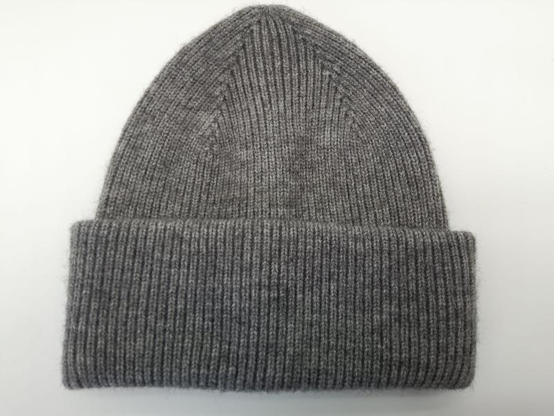 Heather grey ribbed knit beanie hat with wide folded cuff, laid flat on white background, soft wool blend