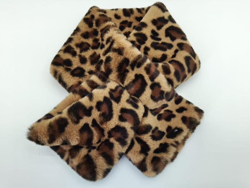 Leopard print faux fur scarf wrap laid flat on white background, showing brown and tan animal print pattern