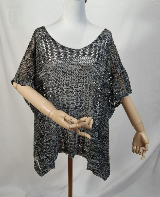 Charcoal grey open-knit crochet poncho top with short sleeves and V-neckline displayed on mannequin
