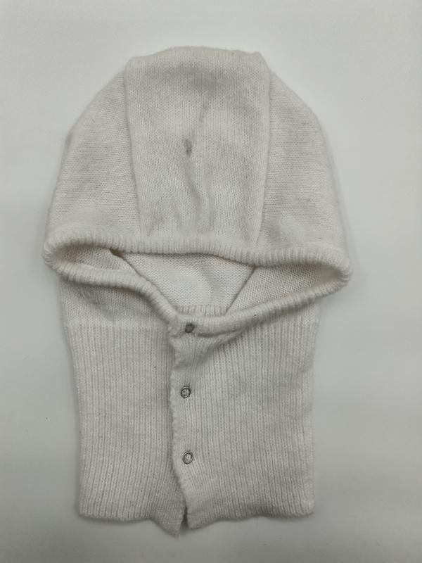 Cream white knitted baby balaclava helmet with fold-over hood and silver snap buttons, laid flat on white background