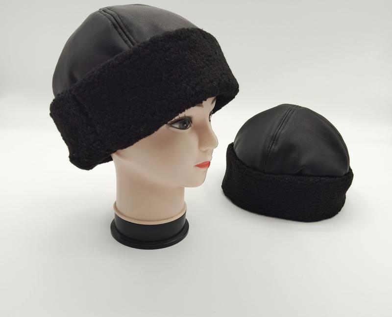 Black faux leather top beanie hat with chunky sherpa fleece cuff shown on mannequin head and standalone on white background