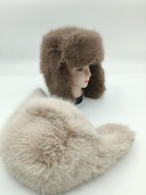 Taupe faux fur ushanka trapper hat displayed on mannequin head with matching fluffy faux fur scarf in foreground