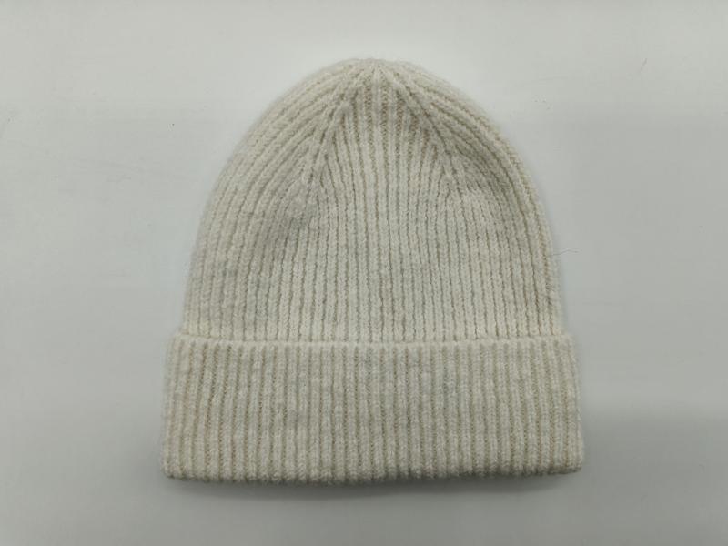 Cream off-white ribbed knit winter beanie hat with folded cuff displayed flat on light grey background