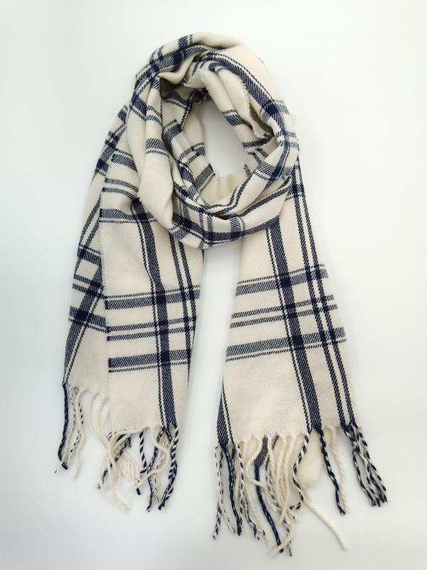 Cream and navy blue plaid woven scarf with twisted fringe ends, looped and laid flat on white background
