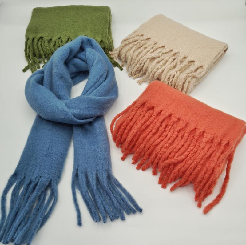 Four fringed wool blend scarves in blue, olive green, beige, and coral orange displayed on white background