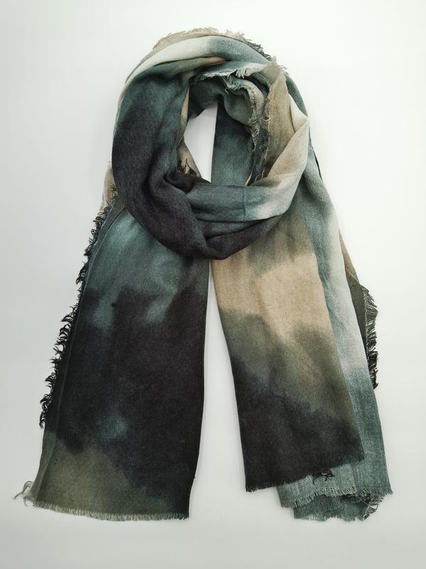 Folded large tie-dye scarf in dark green, charcoal, and taupe ombre pattern with fringe edges on white background