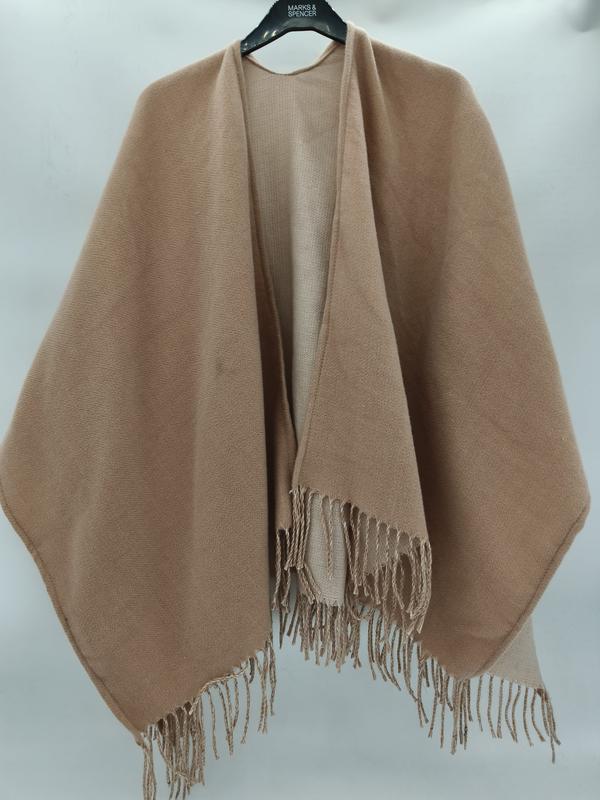 Camel beige open-front woven wrap shawl cape with twisted fringe hem displayed on a hanger