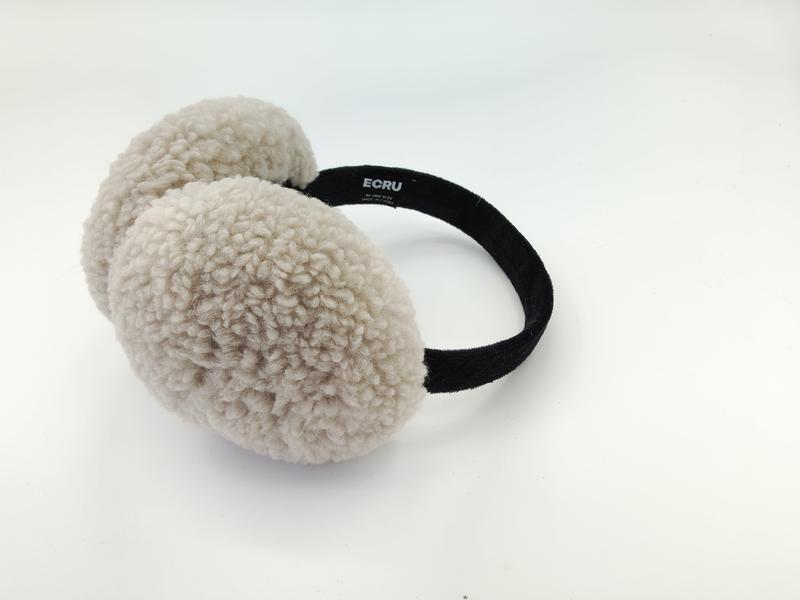 Cream beige sherpa fleece earmuffs with black velvet headband displayed on white background, showing fluffy textured ear cushions