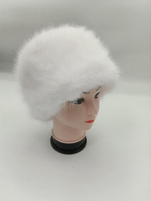 White fluffy faux fur cossack-style winter hat displayed on a mannequin head against a light grey background