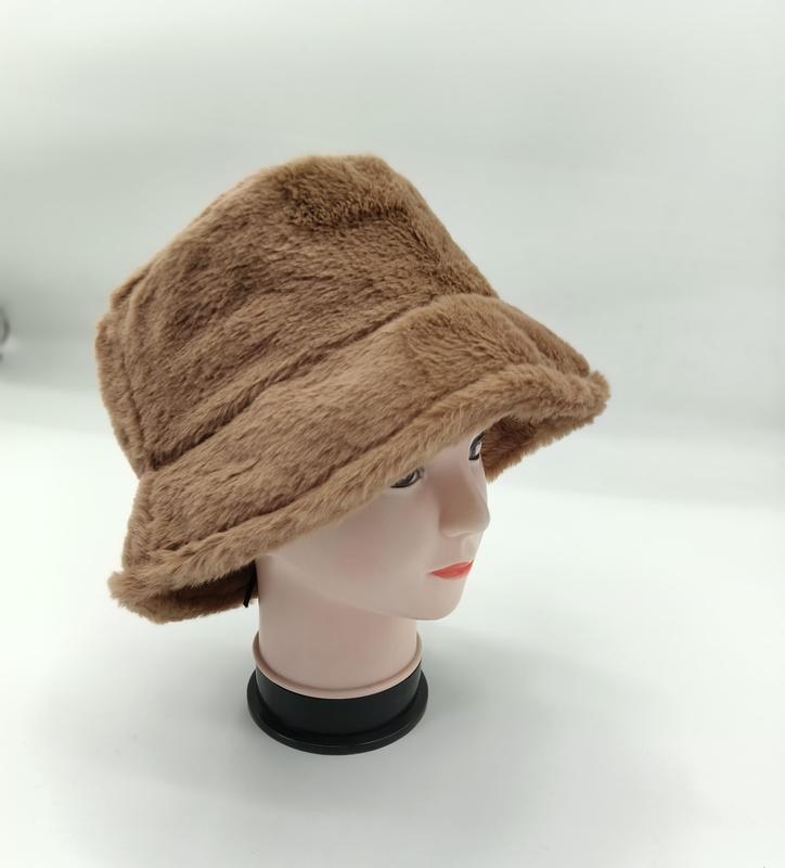 Camel brown faux fur bucket hat displayed on a mannequin head, showing plush fluffy texture and wide brim