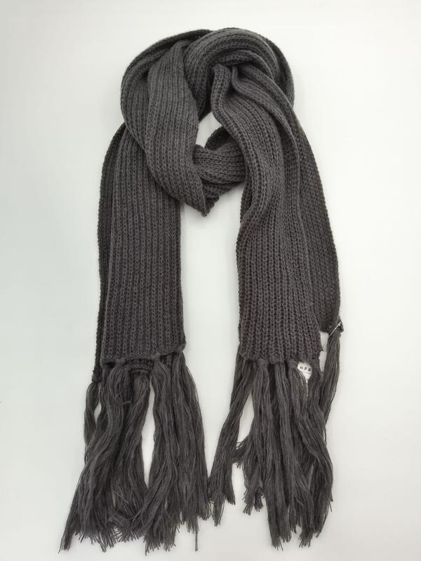 Dark gray chunky ribbed knit winter scarf with long fringe tassels displayed folded on white background