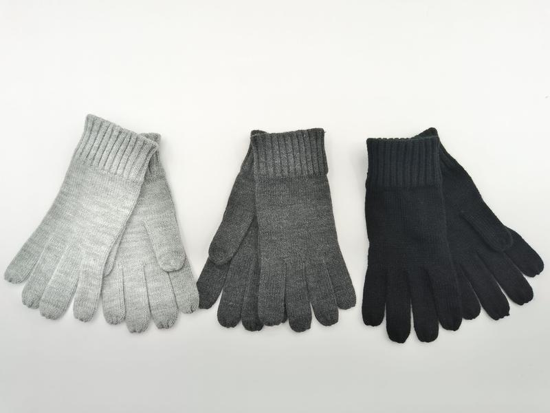 Three pairs of ribbed knit winter gloves in light gray, charcoal gray, and black laid flat on white background