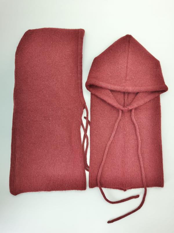 Two-piece dusty rose ribbed knit balaclava hood with drawstring and matching tube scarf laid flat on white background