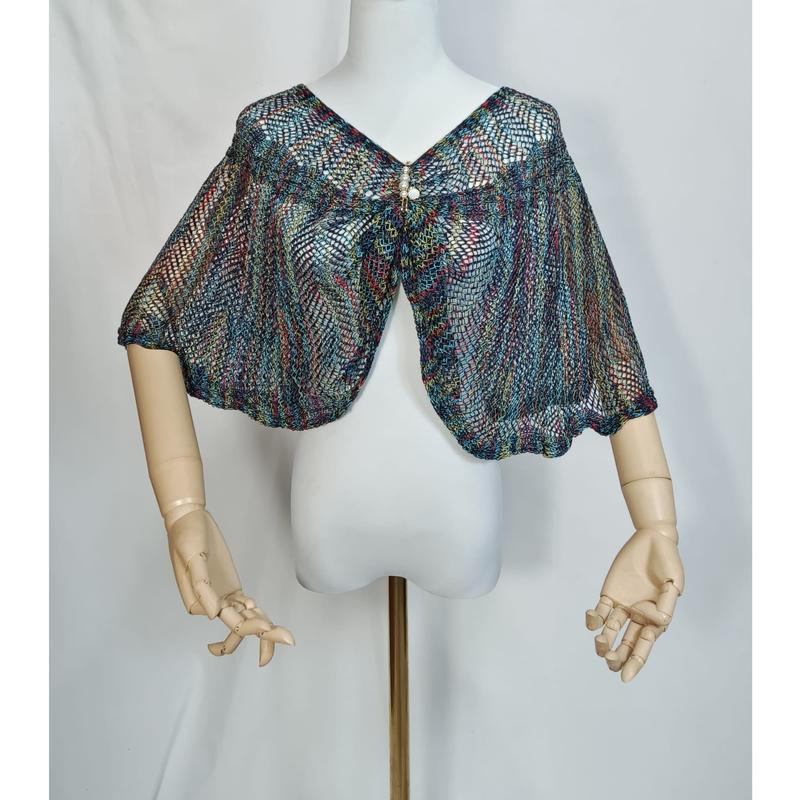 Multicolor open-weave knit capelet in teal, red, and gold displayed on a mannequin with wooden articulated arms