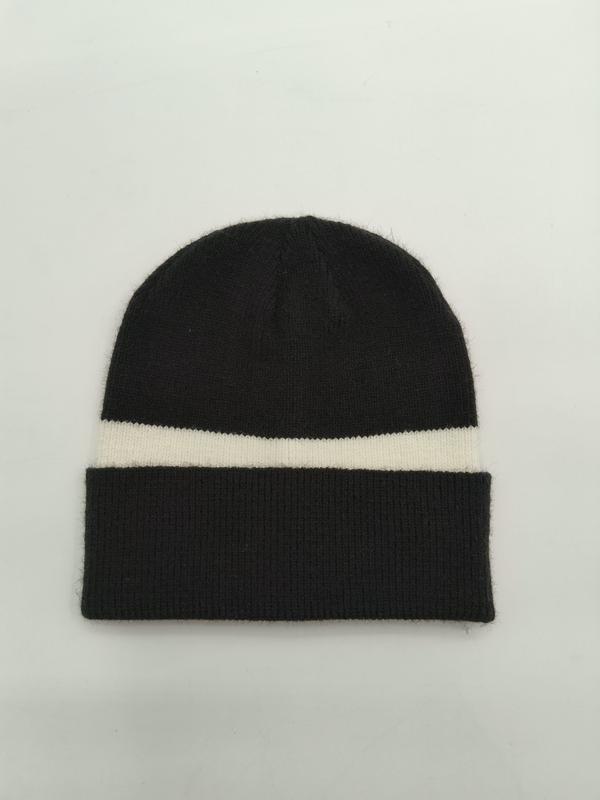 Black knit beanie hat with single cream stripe and folded ribbed cuff, laid flat on white background