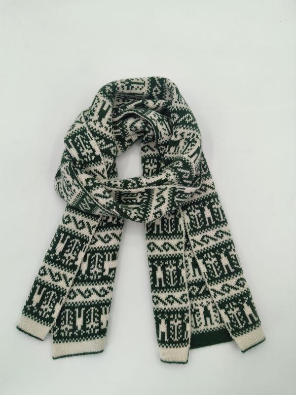 Folded green and cream knitted scarf with Fair Isle Nordic geometric pattern on white background
