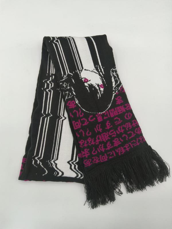 Black knit scarf with white graphic portrait, pink Japanese script text pattern, and black fringe trim ends