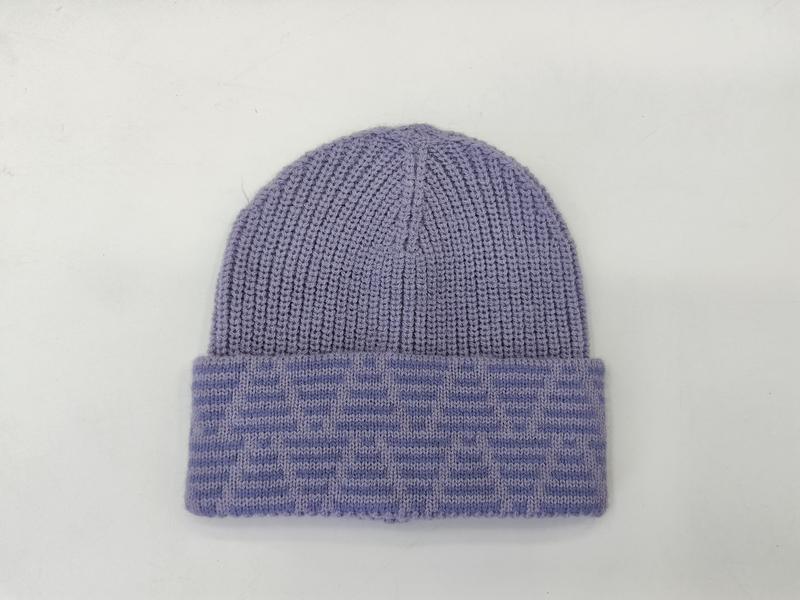 Lavender purple ribbed knit beanie hat with folded jacquard patterned cuff on white background