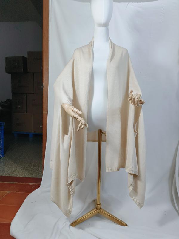 Cream ivory fine knit oversized wrap shawl displayed on mannequin, open front with ribbed hem trim and draped silhouette