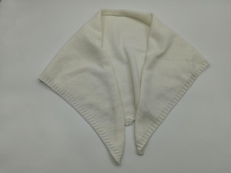 Ivory cream knitted wrap shawl with pointed ends, decorative picot border, and open front collar detail on white background