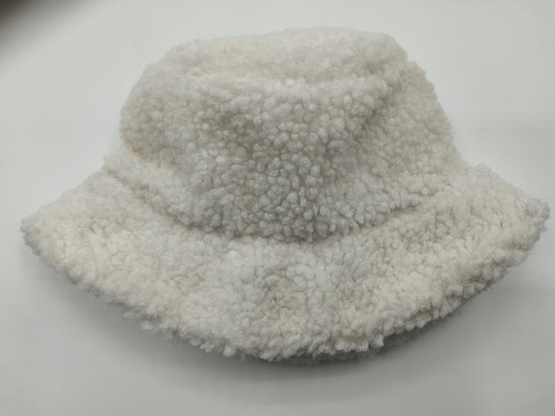 Cream white sherpa fleece bucket hat with fluffy boucle texture, placed on white background, soft winter accessory