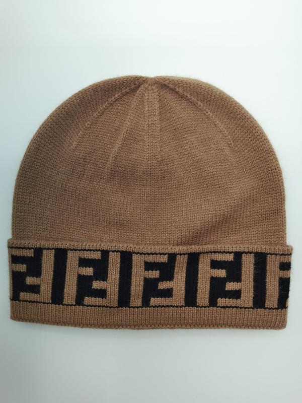 Camel brown fine knit beanie hat with folded cuff featuring repeating black geometric monogram logo pattern