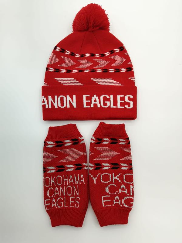 Red knit pom-pom beanie hat and matching arm warmers set with white geometric arrow pattern and team text