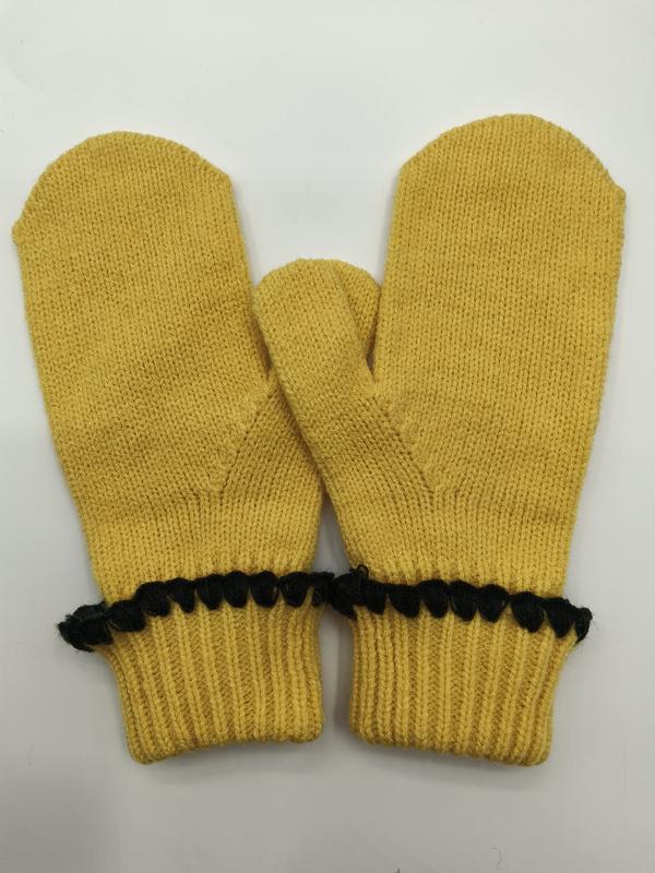 Pair of mustard yellow knitted winter mittens with ribbed cuffs and black decorative pom-pom trim detail