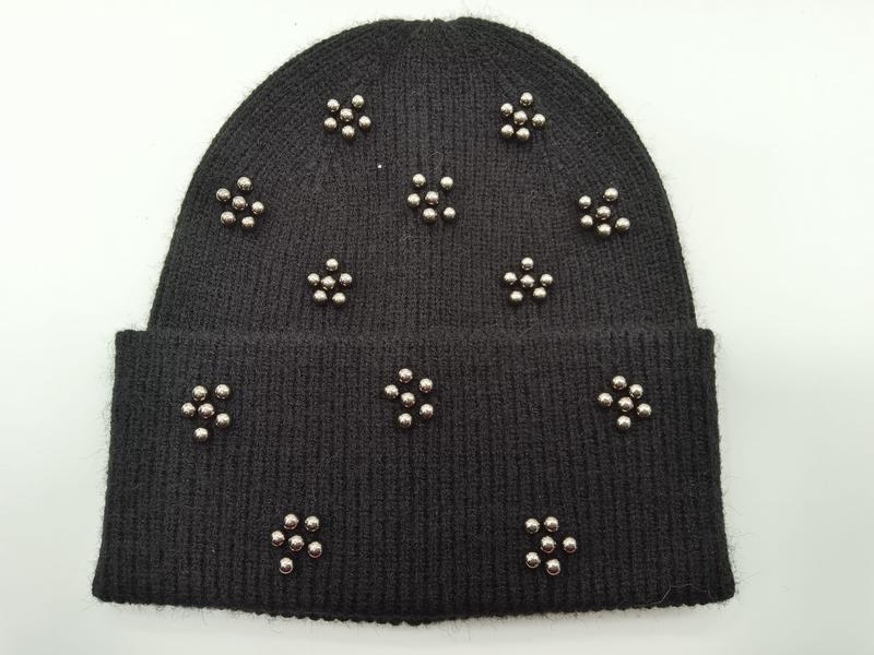 Black ribbed knit beanie hat with silver metal ball stud floral clusters scattered across the cuff and crown