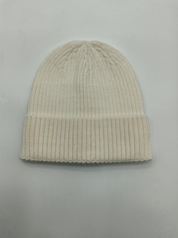 Cream off-white ribbed knit cuffed beanie hat laid flat on white background, showing fine rib texture and folded brim