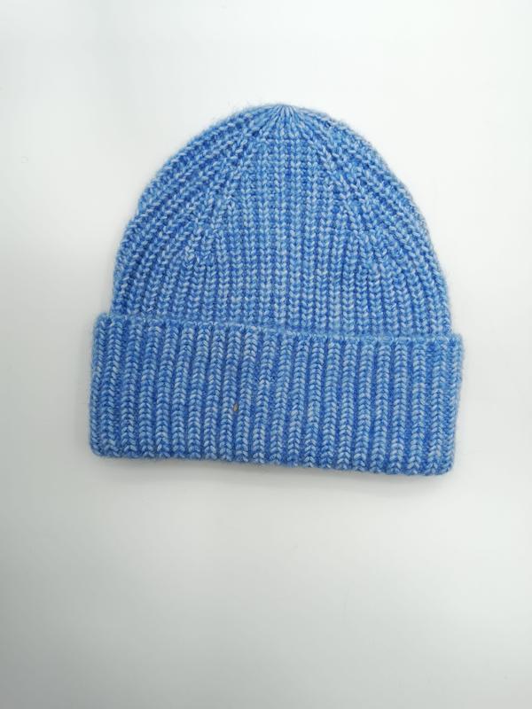 Sky blue marl chunky ribbed knit beanie hat with folded cuff, laid flat on white background