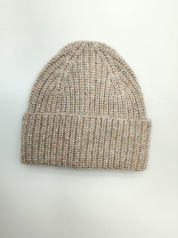 Flat lay of a chunky ribbed knit beanie hat in oatmeal and beige marl with a folded cuff on white background