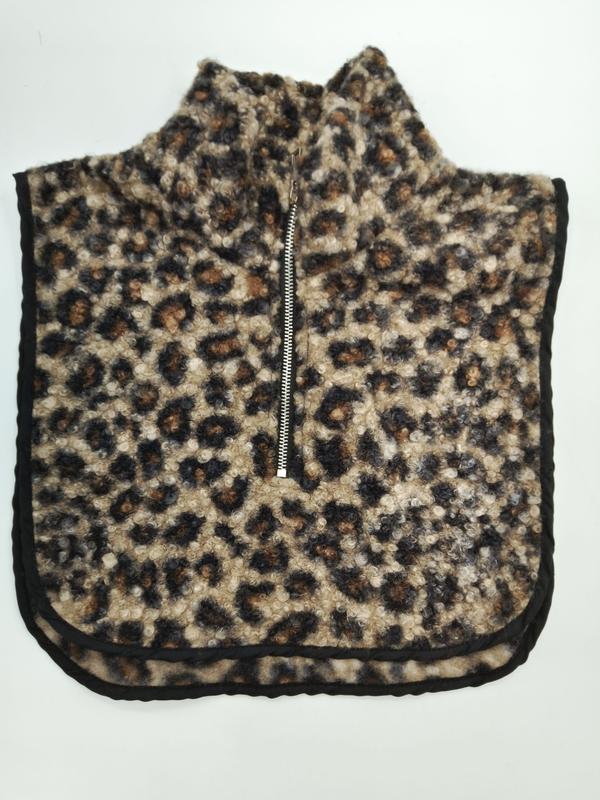 Leopard print sherpa fleece neck warmer dickey with silver half-zip closure and black trim edges, laid flat on white background