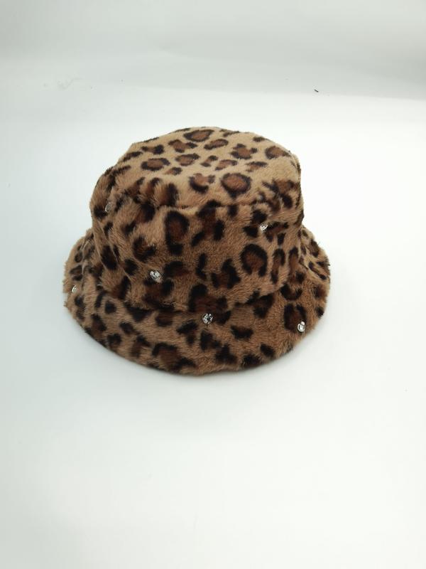 Fuzzy leopard print bucket hat in tan and brown with small crystal rhinestone accents on white background